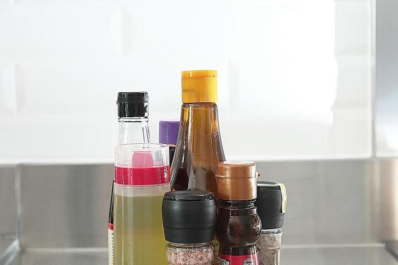 Use a squeeze bottle with small nozzles for cooking oil, so you never pour too much into a pan. An inexpensive lazy Susan makes it easy to spin and grab condiments for cooking. The writer with her pantry after purging and reorganising it. If you can,
