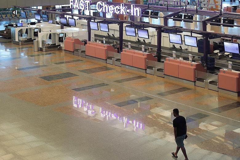 An almost-deserted Changi Airport Terminal 2 last Tuesday, due to a large number of cancelled flights. In the wake of the virus outbreak, cities and countries have closed their borders and people are staying home.