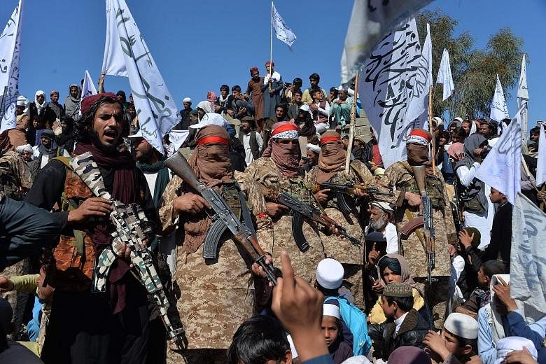 Afghan Taleban militants and villagers celebrating the peace deal signed with the US in Laghman, Afghanistan, on March 2. PHOTO: AGENCE FRANCE-PRESSE