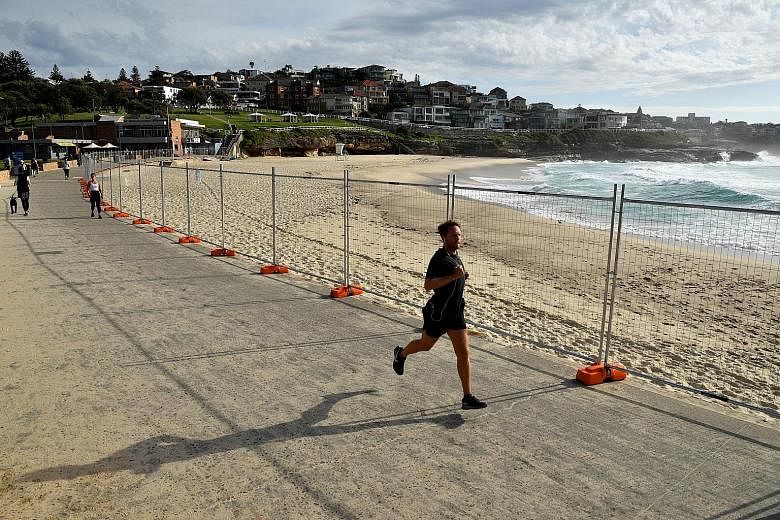 A man running past the closed-off Bronte Beach in Sydney last Wednesday. While there is no national order to stay home, the Australian authorities have urged people to cancel house parties and other social gatherings. PHOTO: EPA-EFE