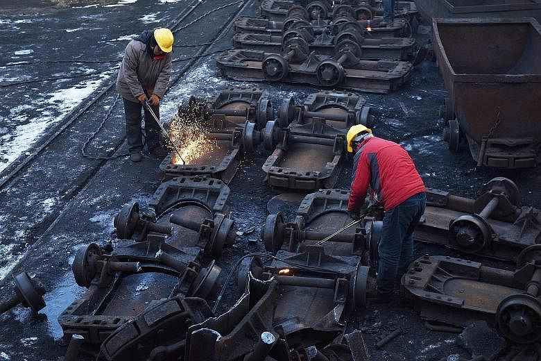Workers cutting up coal carts at the Datai coal mine in Mentougou, west of Beijing, last December. With many investors adopting a wait-and-see attitude amid the coronavirus pandemic and the roll-out of relief packages, some are placing their bets on 