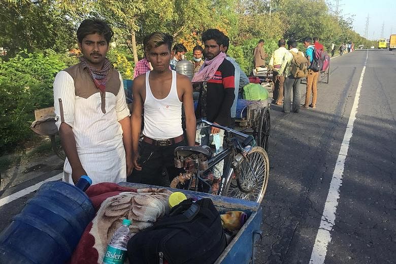 Mr Mohammed Riyaz, 19, (in sleeveless shirt) and his friends on their journey home last Saturday. They were travelling a distance of more than a thousand kilometres between Delhi and their home in Bihar's Supaul district after the Indian government i