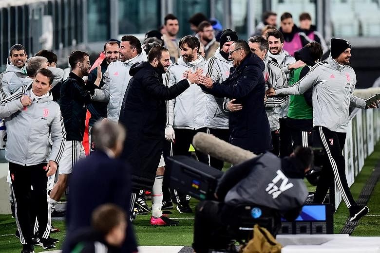 Juventus striker Gonzalo Higuain and manager Maurizio Sarri, seen celebrating their last win, will take a pay cut as the Italian champions attempt to tide over the financial pressure they face with the lack of competitive matches.