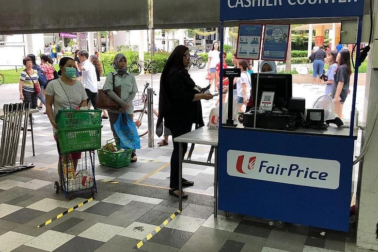 FairPrice is looking at hiring more workers and opening pop-up stores, like this one (above) near its Bedok North store, around the island in the next few days in spaces attached to existing stores. PHOTO: SEAH KIAN PENG