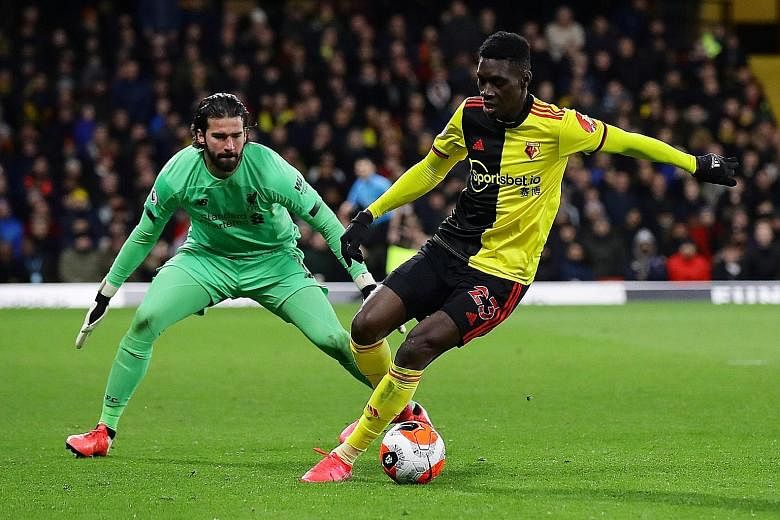 Watford's Ismaila Sarr, coming up against Liverpool goalkeeper Alisson Becker, scored two goals in the stunning 3-0 win over the Premier League runaway leaders at Vicarage Road on March 1. PHOTO: REUTERS