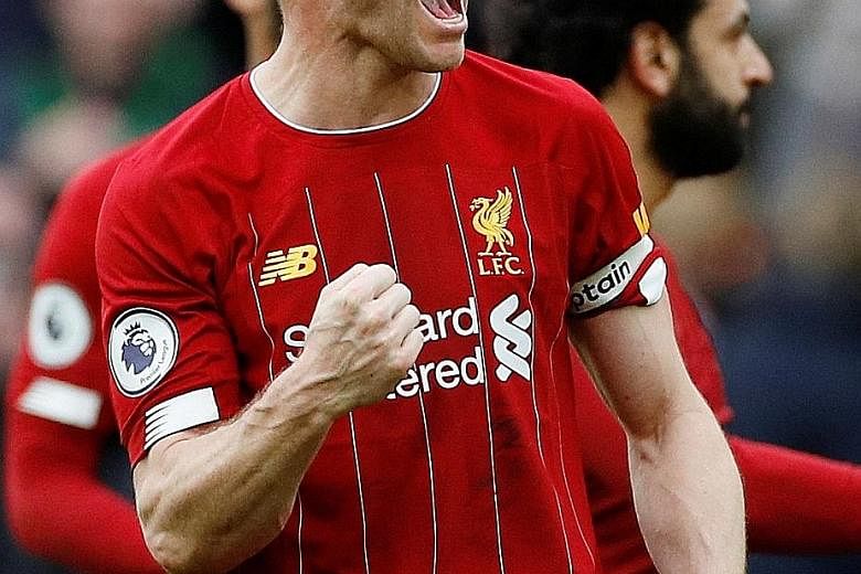 Liverpool's James Milner celebrating after a 2-1 win over Bournemouth on March 7, their last match before the Premier League season was suspended until April 30 owing to the coronavirus pandemic. The Reds top the table on 82 points and need only two 