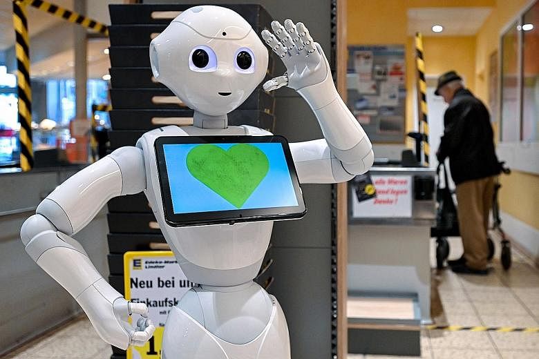 A humanoid robot named "Pepper" reminding customers at a German supermarket to keep a safe distance from one another to minimise the transmission of the coronavirus.