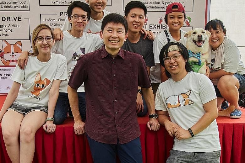 Volunteer group Hope for Animals, founded in 2011 by creative designer Melodee Tan (far left), has started Project Pet Live, a series of virtual adoption drives. With the group's volunteers at an event earlier this year is Senior Minister of State fo