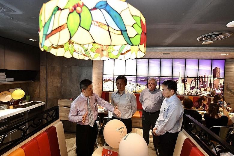 Trade and Industry Minister Chan Chun Sing visiting a Swensen's outlet at Bugis Junction yesterday with (from left) Mr Benny Ng, general manager of operations at ABR Holdings, the parent company of Swensen's; Mr Keith Chua, executive chairman of ABR 