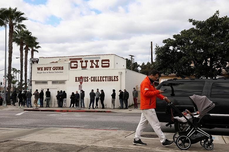 A line outside a gun store amid fears of the growth of coronavirus cases, in Culver City, California, on March 15. A gun-store owner in Los Angeles County reported a surge in Asian customers in recent months. Many Asian Americans have gone online to 