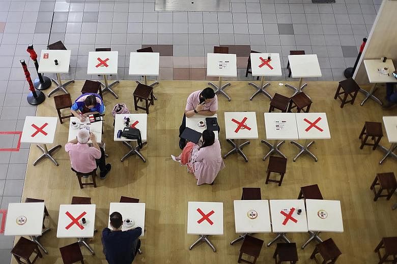 Diners practising social distancing at People's Park Centre on Monday. In his exclusive interview with The Straits Times, National Development Minister Lawrence Wong said it is important to "get all Singaporeans to understand that every person is, in