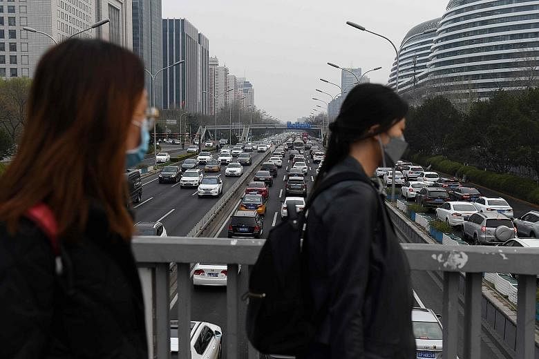As Beijing gingerly stepped up its back-to-work experiment yesterday, streets, which for weeks had barely any traffic, started to get filled with cars and Beijing's Second Ring Road (above), a major thoroughfare going through the capital, even had sl