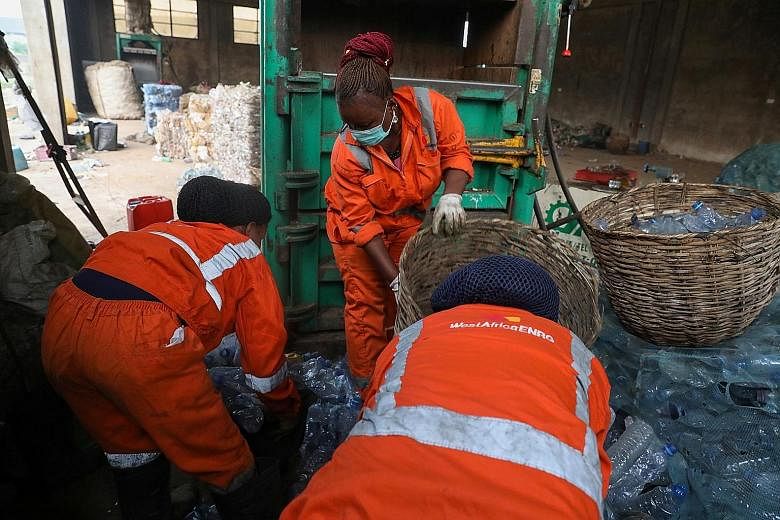 Workers of a material-recovery facility sorting plastic bottles in Lagos, Nigeria. Four of the world's largest consumer brands - Coca-Cola, PepsiCo, Nestle and Unilever - are responsible for half a million tonnes of plastic pollution annually in the 
