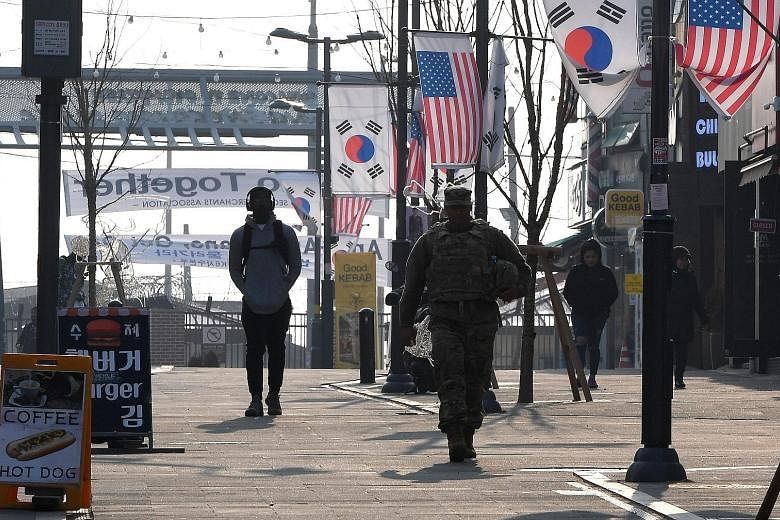 In this 2019 photo, a US soldier is seen in a shopping zone outside US Camp Humphreys in Pyeongtaek city, South Korea. The decades-old military alliance between the US and South Korea was dealt a blow yesterday when the US military put almost half of