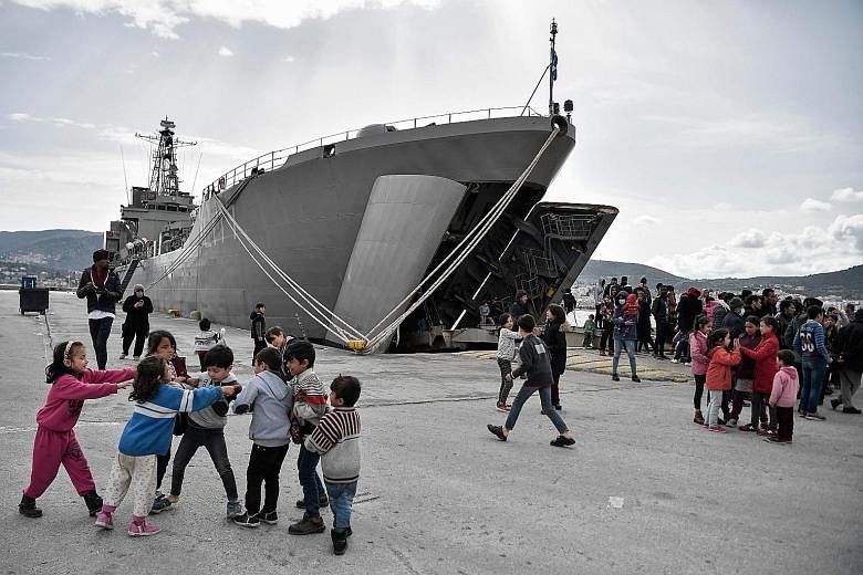 A military carrier used to carry refugees and migrants docked at the Greek island of Lesbos on March 7. The European Court of Justice has found that Poland, Hungary and the Czech Republic failed to fulfil their obligations to take in migrants under E