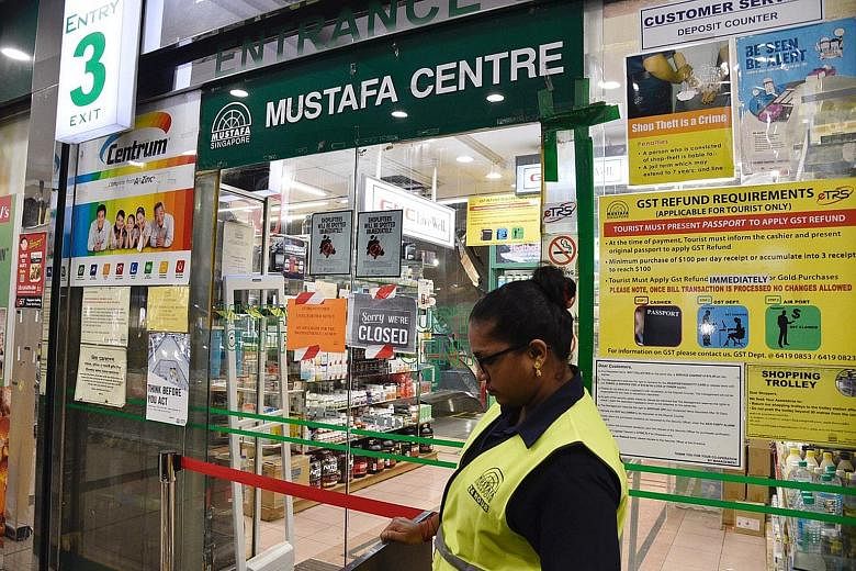 A sign put up late last night at the 24-hour Mustafa Centre, announcing that it would be closed until further notice. A total of 11 cases - including those announced earlier - have been linked to the cluster.