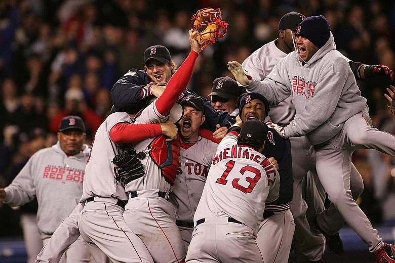 The Boston Red Sox celebrate winning the American League Championship Series after defeating the New York Yankees 10-3 in Game 7 at the Yankee Stadium in 2004. They went on to thrash the St Louis Cardinals 4-0 to win the World Series for the first ti