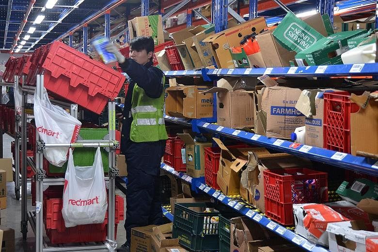 E-grocer RedMart has started prioritising the sale of daily essentials such as milk powder and rice and made changes to its logistics to cater to the rising demand. ST FILE PHOTO