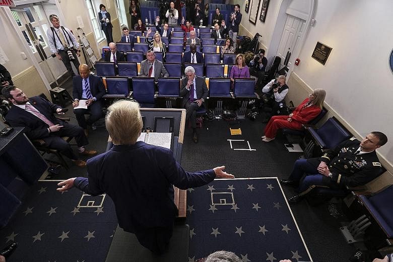 President Donald Trump addressing the media during a daily briefing on Covid-19, in the White House press briefing room on Wednesday. PHOTO: EPA-EFE Father Brian Mahoney hearing a parishioner's confession in the carpark of St Mary's Church in Chelmsf