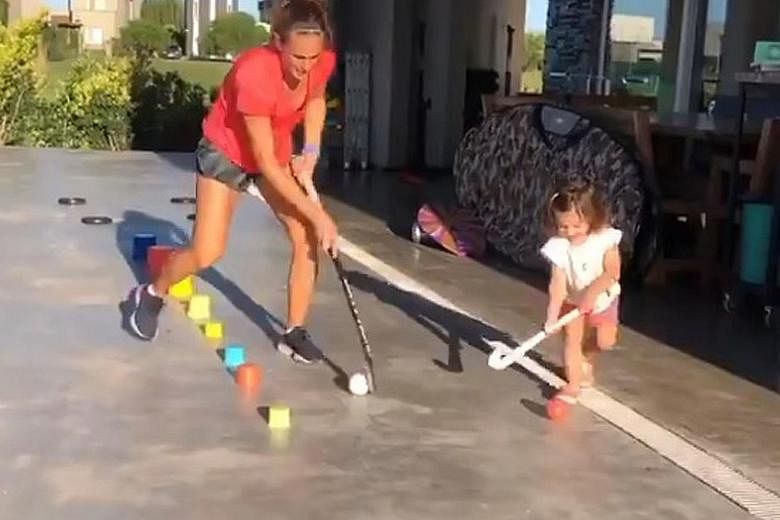 Argentina hockey player Carla Rebecchi and her little one getting their practice.