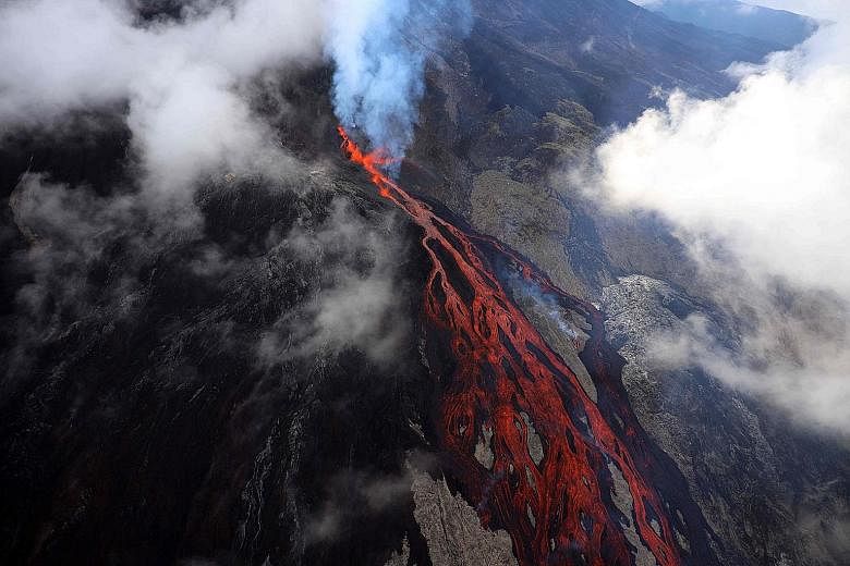 Lava oozing down the Piton de le Fournaise volcano during an eruption on Thursday. The volcano on the French Indian Ocean island of La Reunion ranks among the world's most active and has erupted more than 150 times since the 17th century, according t