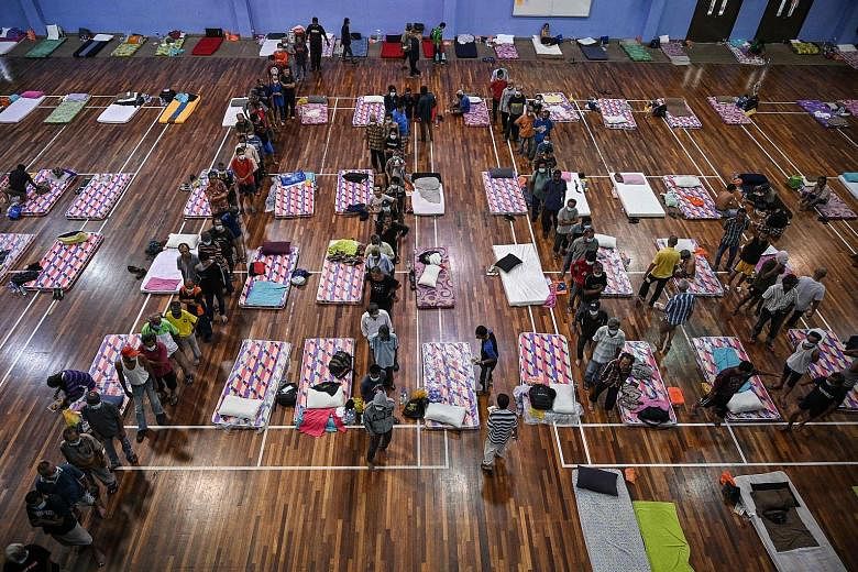 Homeless people queueing for food at a shelter in Kuala Lumpur last Thursday during Malaysia's ongoing movement control order.