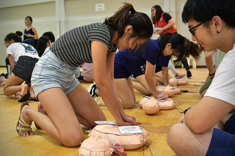 Participants practising cardiopulmonary resuscitation on dummies with Red Cross instructors at a life-saving workshop organised by a group of Nanyang Technological University communication students on Feb 27.