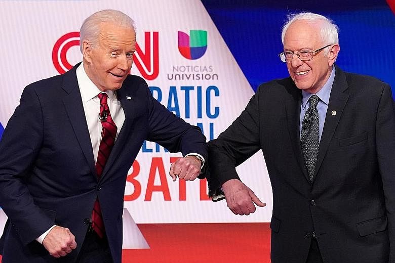 Mr Joe Biden and Senator Bernie Sanders doing an elbow bump instead of a handshake ahead of a Democratic Party debate in Washington last month.