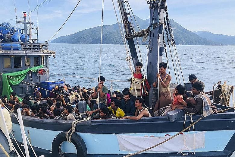 A photo from the Malaysian Maritime Enforcement Agency showing a wooden boat carrying suspected Rohingya migrants who had been detained in Malaysian territorial waters, off the island of Langkawi, yesterday. A boatload of more than 200 Rohingya refug