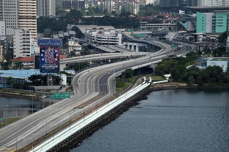 A traffic-free Causeway after Malaysia imposed its movement control order on March 18. The Malaysiakini news portal said Malaysians who are returning home should undergo a swab test in Singapore and present the certificate at the entry points.