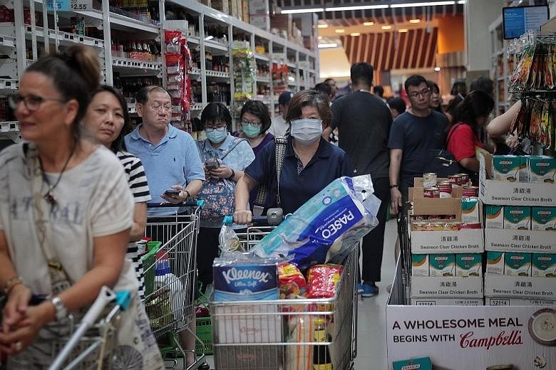 Shoppers at the FairPrice outlet in Jem. Trade and Industry Minister Chan Chun Sing reiterated reassurances that the country has enough supplies to meet its needs, but stressed that Singaporeans had a part to play. "No amount of stockpile will ever b
