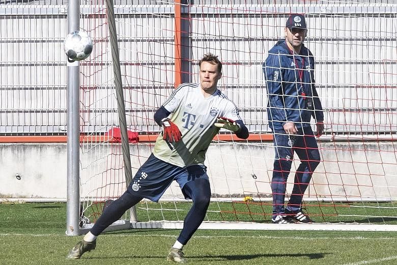 Bayern head coach Hansi Flick, who last week signed a contract extension to 2023, watching goalkeeper Manuel Neuer as the Bavarian side resumed training in groups of five and without contact in Munich yesterday. The Bundesliga remains suspended until