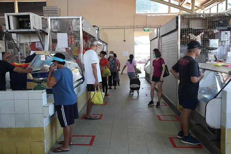 People shopping at Serangoon Garden Market last Saturday. The additional payments announced yesterday, which are meant to help households cope with the impact of the coronavirus pandemic, will cost the Government an extra $1.1 billion. ST PHOTO: TIMO