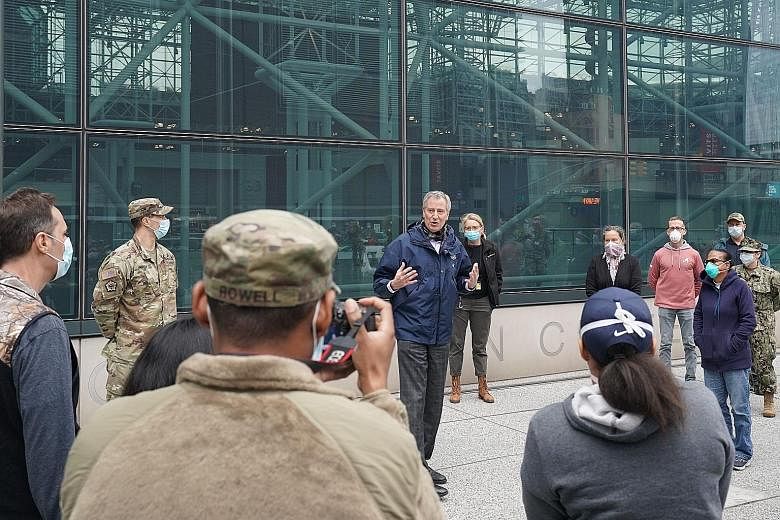 New York City Mayor Bill de Blasio welcoming medics from the US Navy who have volunteered to join the Army's 44th Medical Brigade in treating patients at the Jacob K. Javits Centre. PHOTO: AGENCE FRANCE-PRESSE