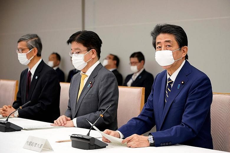 Japanese Prime Minister Shinzo Abe yesterday said he was in good health but promised to self-isolate at the slightest sign of infection. He also appealed for calm and rationality amid the pandemic. PHOTO: AGENCE FRANCE-PRESSE