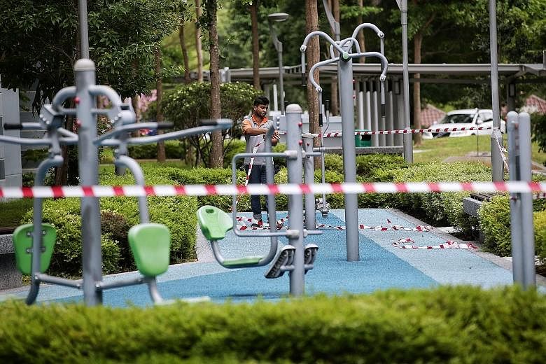 An exercise station in Pasir Ris being cordoned off as part of stricter social distancing measures. These measures would be deemed a resounding success if the number of daily cases falls to the single-digit zone by May 4, when the circuit-breaker pha
