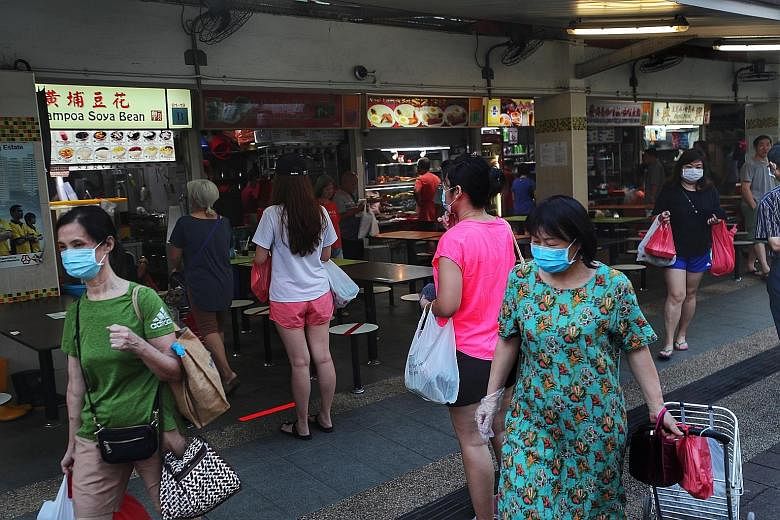 A handwritten sign at an eatery in North Bridge Road reminds customers that they cannot dine in and can buy food only to take away. Fifteen markets, including Geylang Serai Market (above) and Tiong Bahru Market, have set up controlled entry and exit 