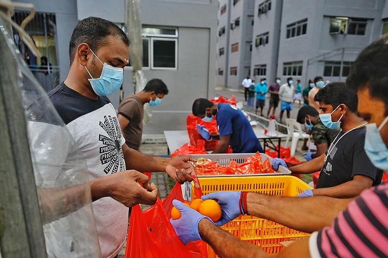 Fruits being distributed to foreign workers under quarantine at Toh Guan Dormitory. The Manpower Ministry said it has taken into account the workers' feedback and increased their meal portions.