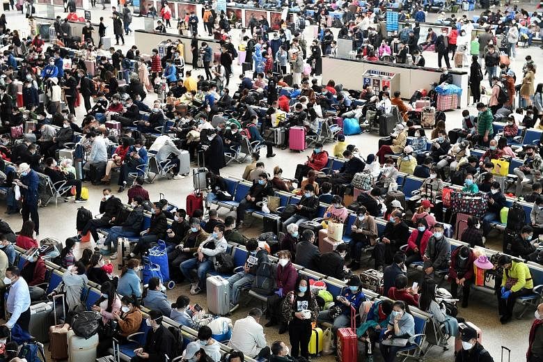 Travellers waiting inside Wuhan's Hankou Railway Station on Wednesday after travel restrictions to leave the city were lifted.