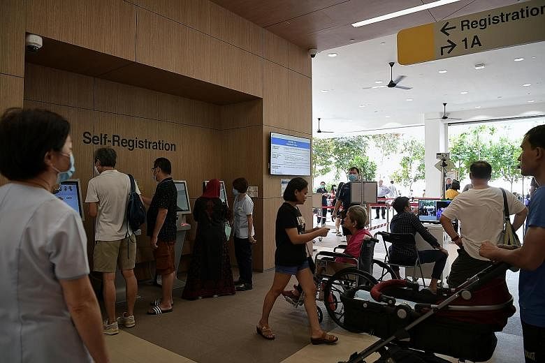 People using the self-registration counters at Ang Mo Kio Polyclinic in February. All 20 polyclinics will now provide swab tests for the coronavirus, along with a number of general practitioner clinics. ST PHOTO: KUA CHEE SIONG
