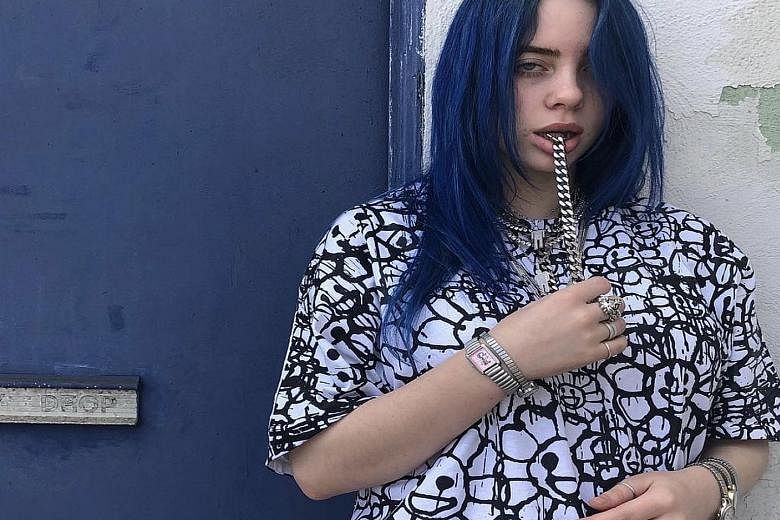 Teenage singer Billie Eilish (left) is among a new generation of stars doubling down on timepieces. Double-wristing has crept into hip-hop circles - rapper Drake (above) wore double Rolexes in his 2012 video for The Motto.
