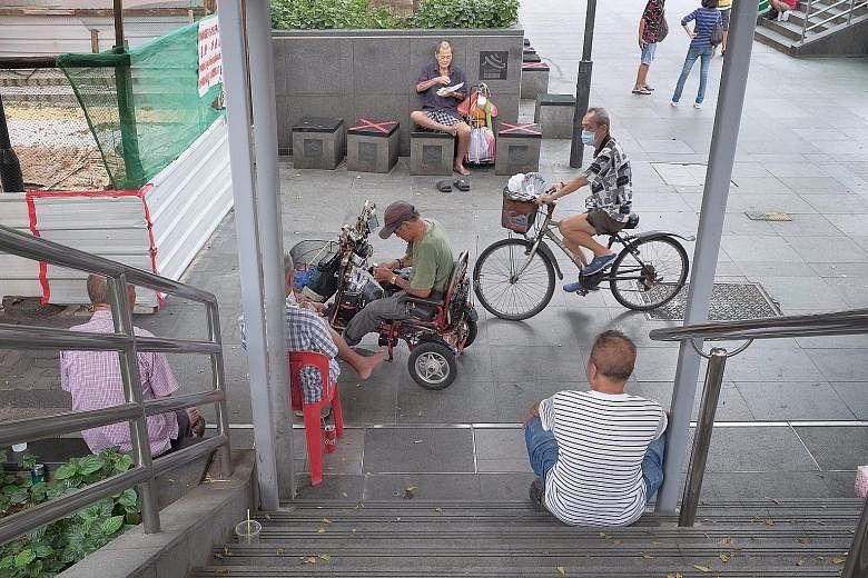 A group of men sitting at a flight of stairs in Chinatown yesterday afternoon. The circuit breaker measures can work only if everyone plays his or her part. More than 1,900 people have been infected, and six have died. A group of men chatting outside