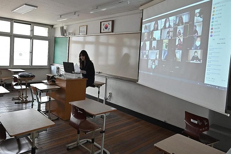 A teacher in Seoul conducting an online class for her students who are staying home amid measures to contain the coronavirus outbreak in South Korea. The country started the new school term yesterday with virtual classes for middle and high school se