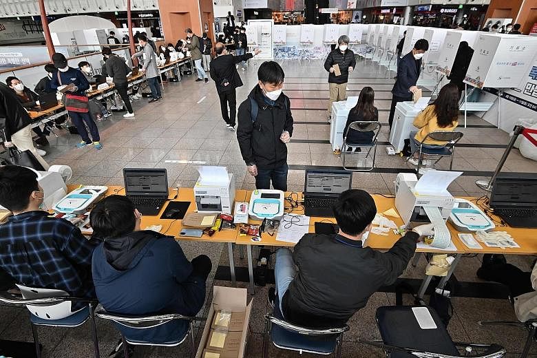 South Koreans casting their ballots at a polling station in Seoul yesterday, ahead of next week's parliamentary election.