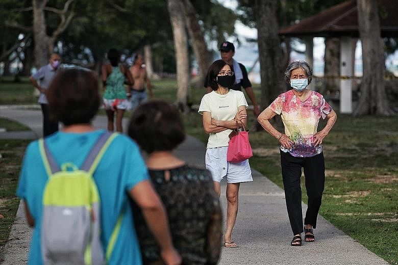 KALLANG ESTATE MARKET Some seniors were spotted having breakfast together at 6.35am yesterday and not observing safe distancing rules. ST PHOTO: DESMOND WEE EAST COAST PARK Elderly people were still spotted taking strolls at East Coast Park yesterday