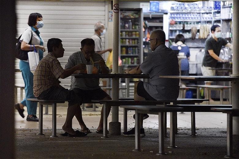 KALLANG ESTATE MARKET Some seniors were spotted having breakfast together at 6.35am yesterday and not observing safe distancing rules. ST PHOTO: DESMOND WEE EAST COAST PARK Elderly people were still spotted taking strolls at East Coast Park yesterday