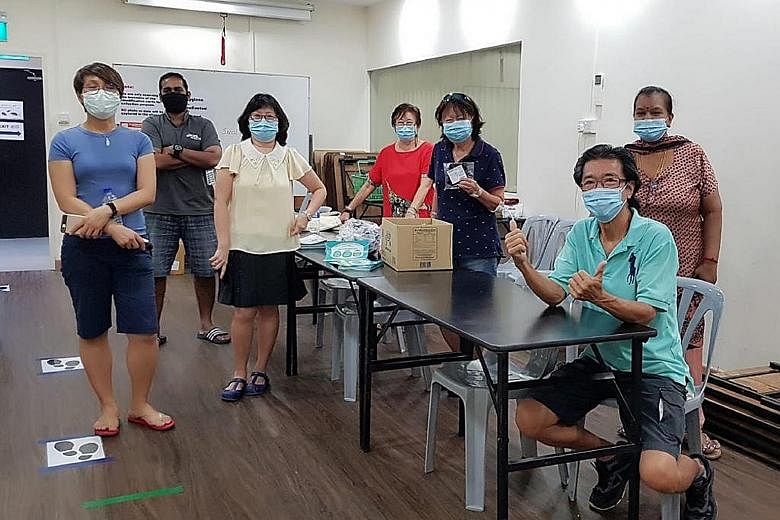 Mr Bernard Chiang (seated) with volunteers from the Braddell Heights Zone B Residents' Committee and Inter-Racial and Religious Confidence Circle during the reusable mask distribution.