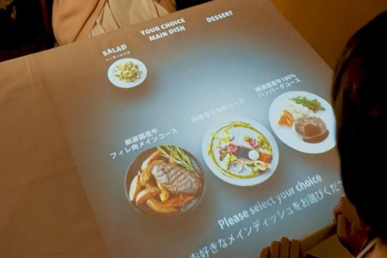 Toshiba Tec is creating menus projected on tabletops. It uses sensors to take customers' orders, effectively turning the entire table into an order system. PHOTO: TOSHIBA TEC An image of a "congestion level" display that can advise users in advance h