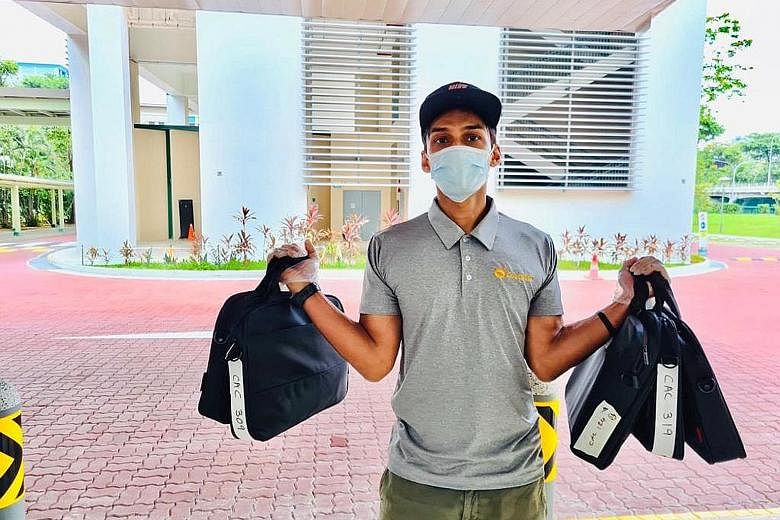 Former national sprinter U. K. Shyam delivering the first batch of laptops to a school on Monday. The 10 recipients also got a note handwritten by a national athlete and a video from Olympic gold medallist Joseph Schooling. PHOTO: TEAMSG