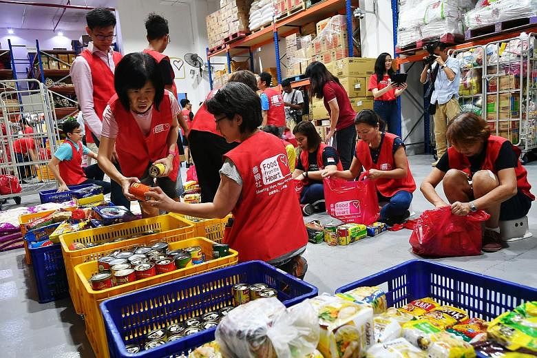 Volunteers helping to pack food at Food from the Heart in February. Minister for Social and Family Development Desmond Lee on Monday said many social service agencies and volunteer groups have asked if they can continue with their community service o